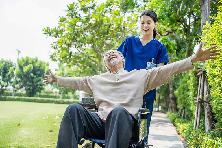 caregiver doctor pushing elderly patient raising a 2025 03 26 14 05 19 utc | Dunham Care Homes