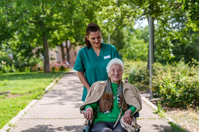 senior woman in wheelchair enjoying sunny day with 2025 03 09 15 32 25 utc | Dunham Care Homes